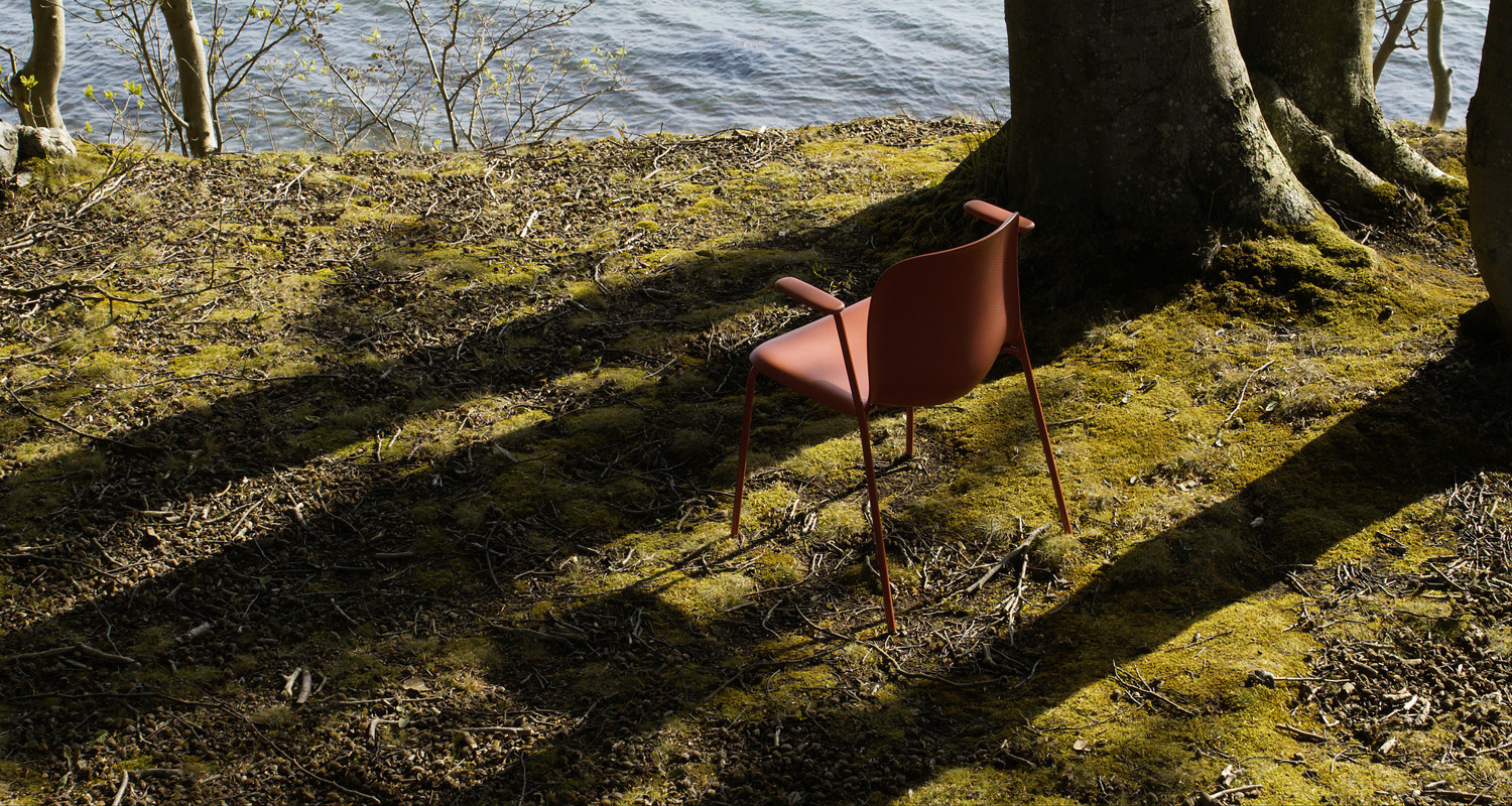 SixE red chair captured on a hill by the sea